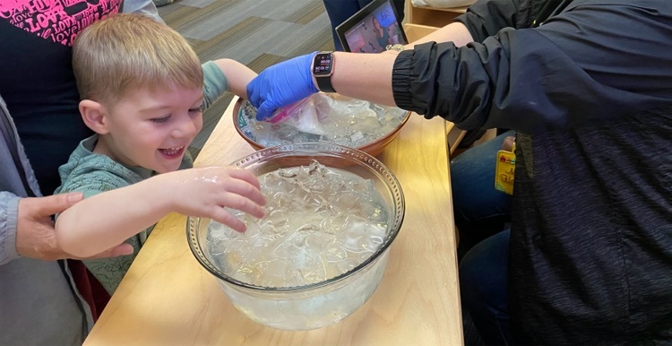student participating in blubber experiment